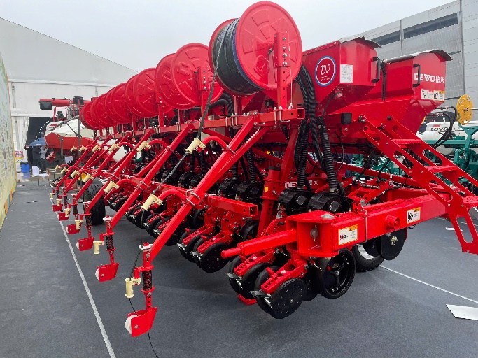 A row of red agricultural machineryDescription automatically generated